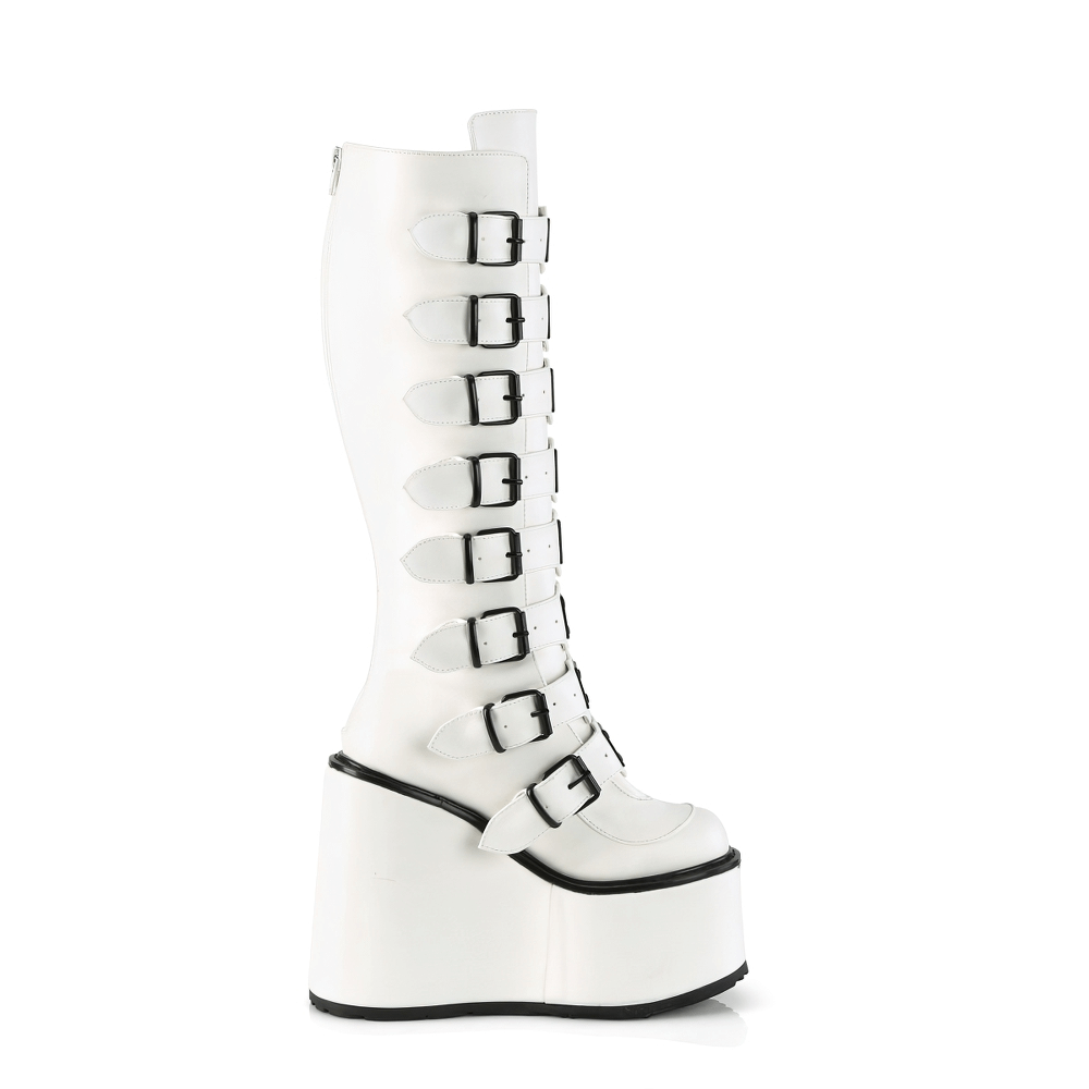 Demonia white knee-high platform boots with buckle straps and a bold, edgy style.