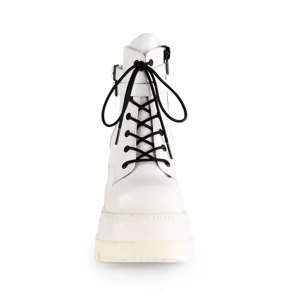 Demonia white platform ankle boots with buckled straps and lace-up front, perfect for edgy minimalist outfits.