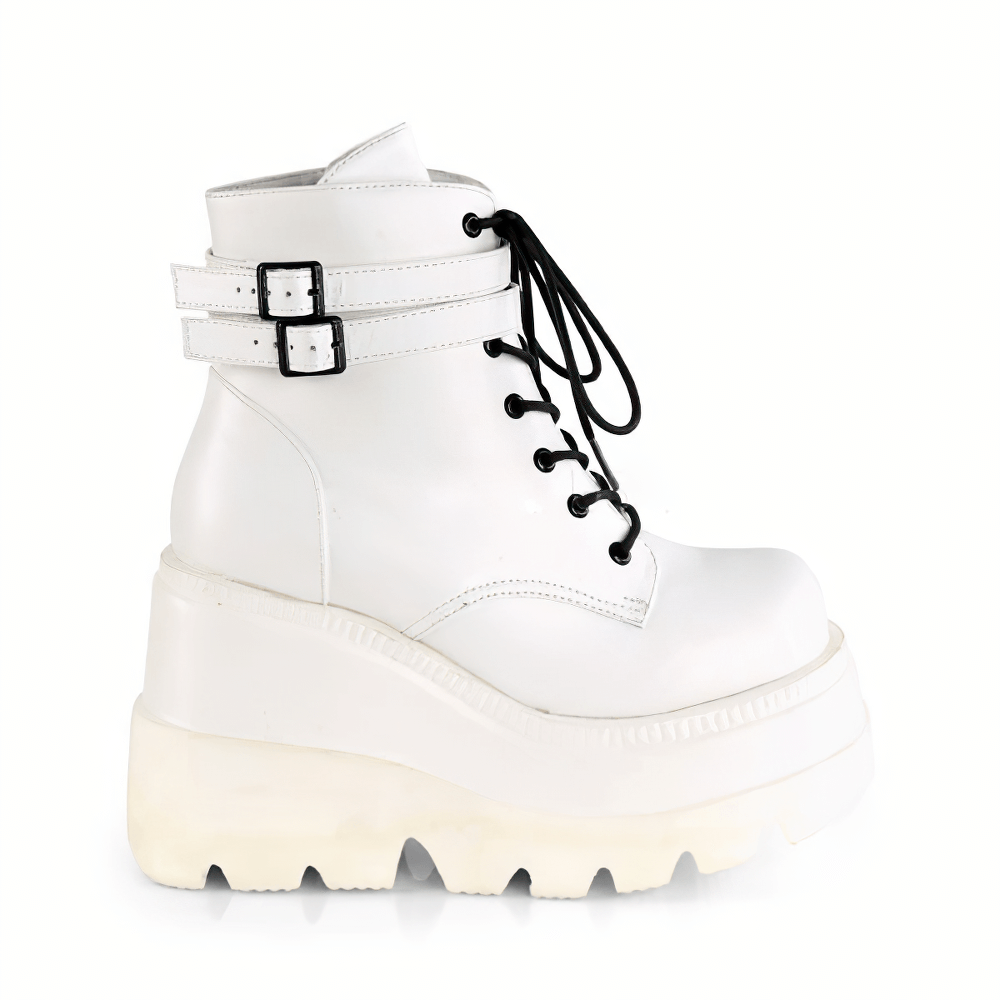 Daring white vegan leather platform ankle boots with buckled straps and lace-up front.