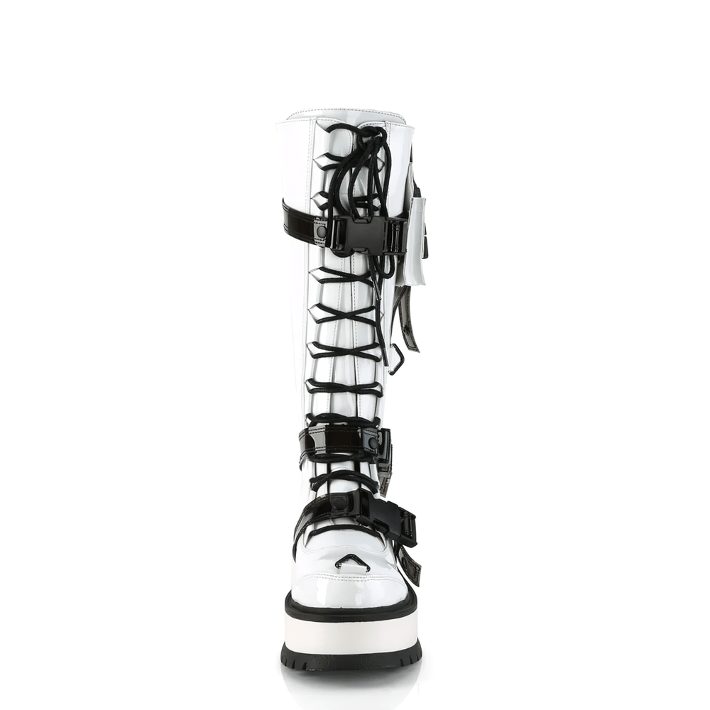 Demonia white knee-high platform boots with buckles and side pocket, featuring a bold lace-up design and edgy details.