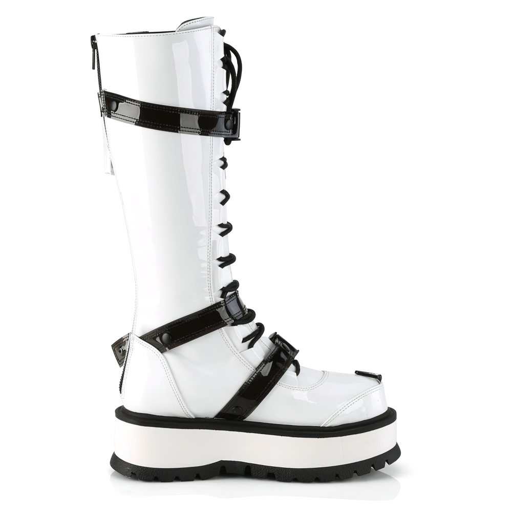 Demonia white platform knee-high boots with buckles and lace-up detail, featuring a side pocket and striking patent finish.