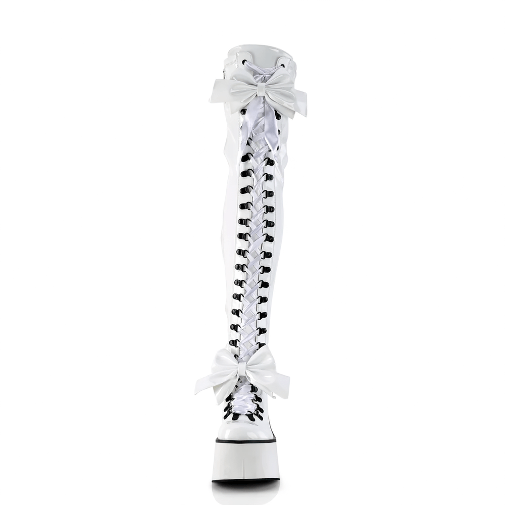 Demonia white thigh-high lace-up boots with oversized bows and adjustable straps on a platform sole.