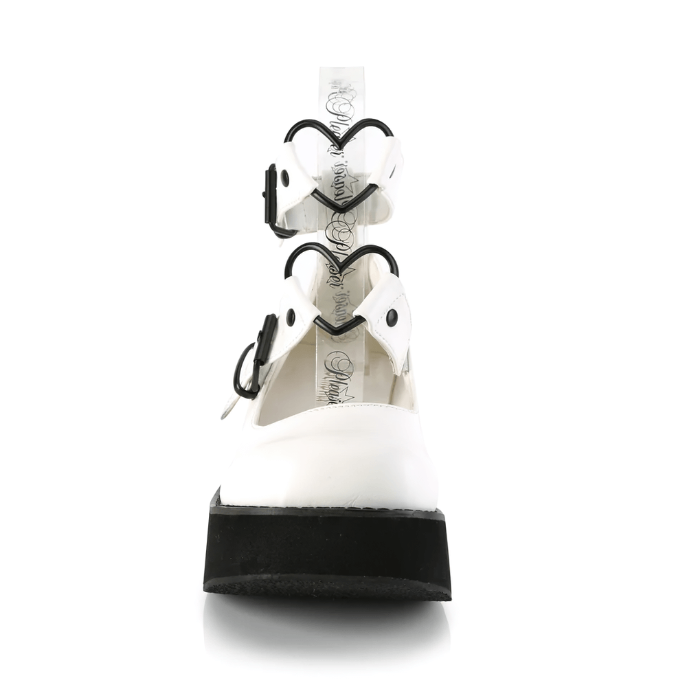 Front view of DEMONIA white vegan leather Mary Janes with heart buckle details and black platform.