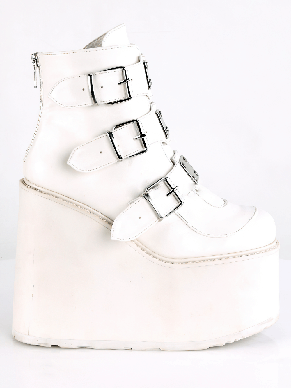 Demonia white wedge platform ankle boots with triple buckle straps and back zipper detail.
