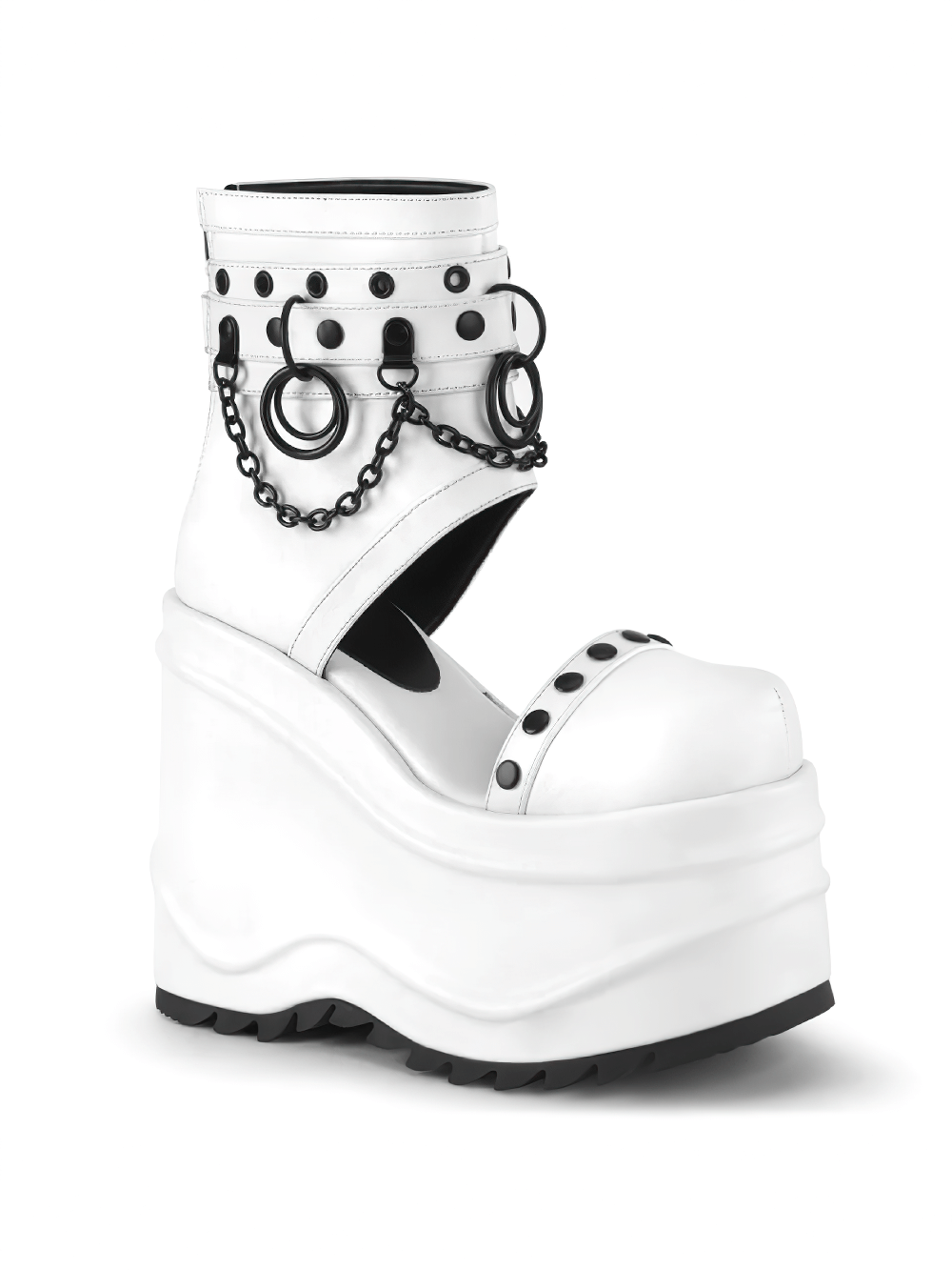 Bold white wedge platform booties with chains, O-rings, and studs, highlighting punk aesthetics and architectural design.