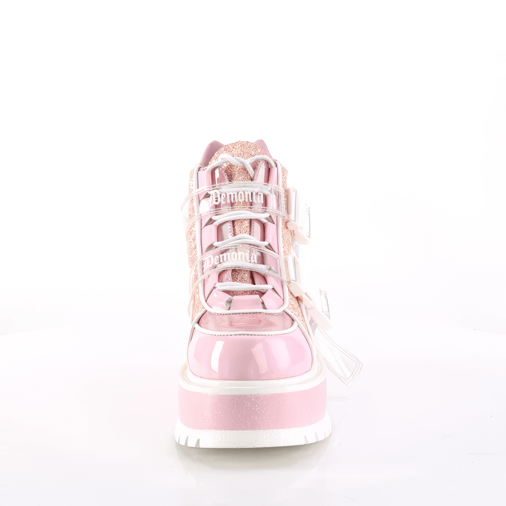 Front view of DEMONIA pink glitter ankle boots featuring lace-up design and dual buckles.
