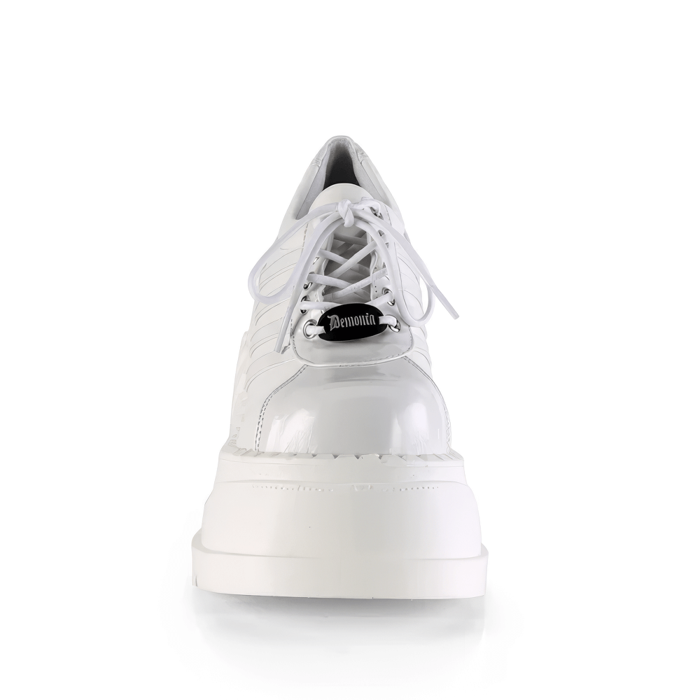 Demonia Women's White Lace-Up Platform Sneakers with 4 3/4" wedge, crafted in vegan leather, perfect for eco-conscious fashion.