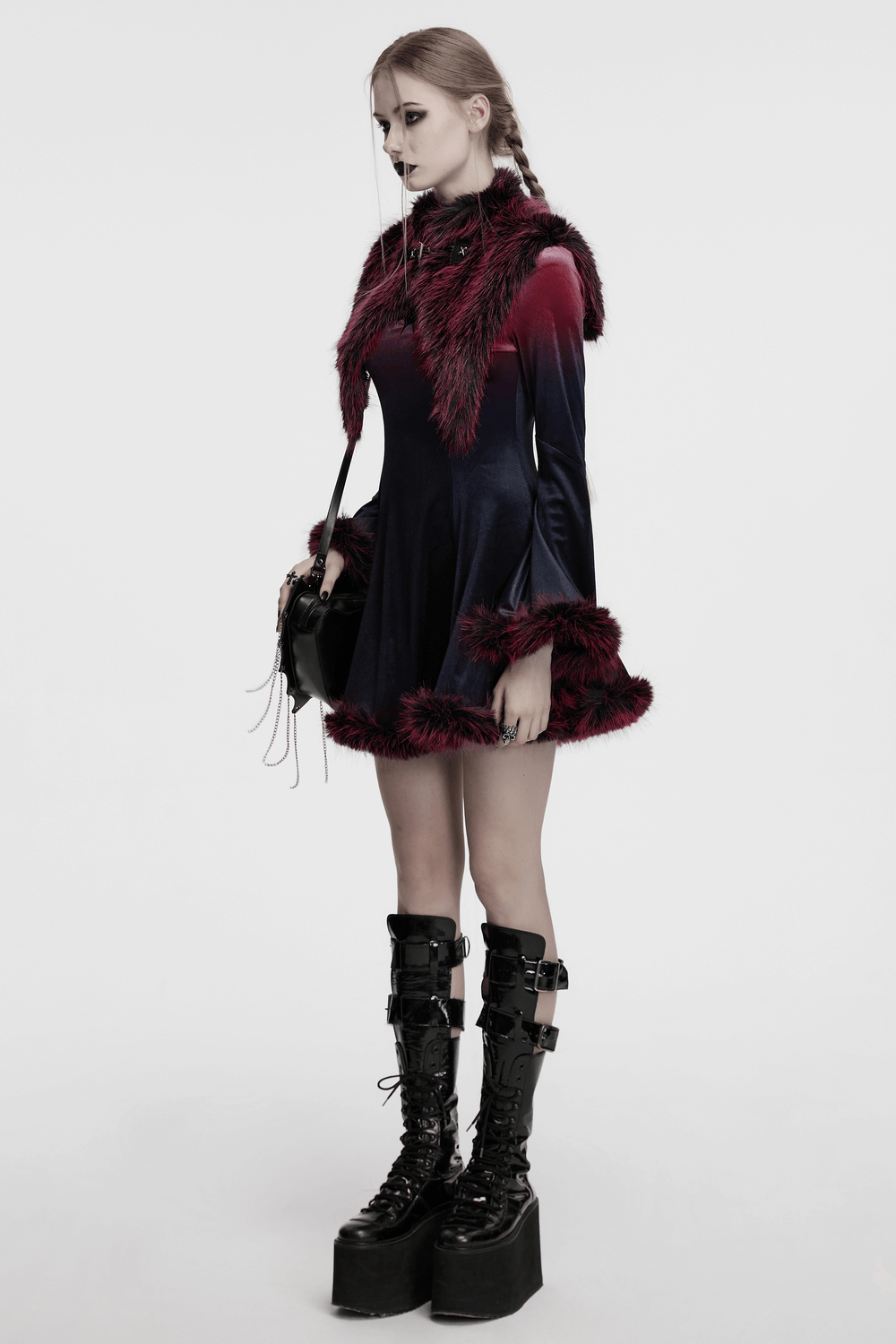 Model showcasing a dual-tone devil fur cape dress with stand collar and leather details in striking colors.