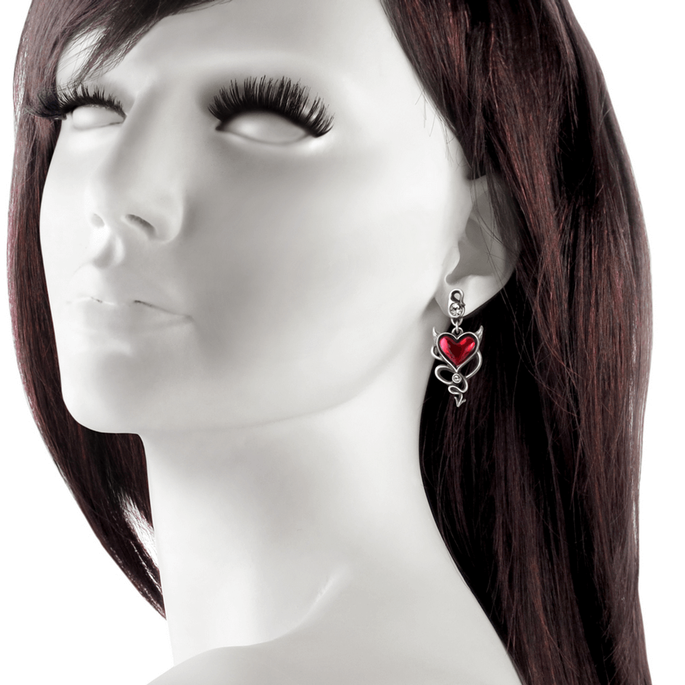 Gothic devil's heart pendant earrings with winged design and crystal accents worn by mannequin.