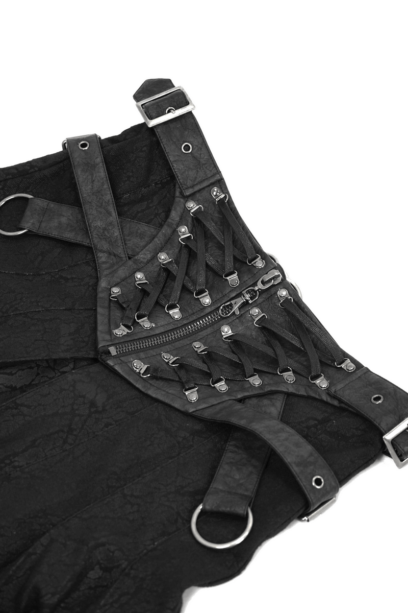 Detail of men's black asymmetric kilt skirt featuring stylish buckled leather straps and silver metal rivets.