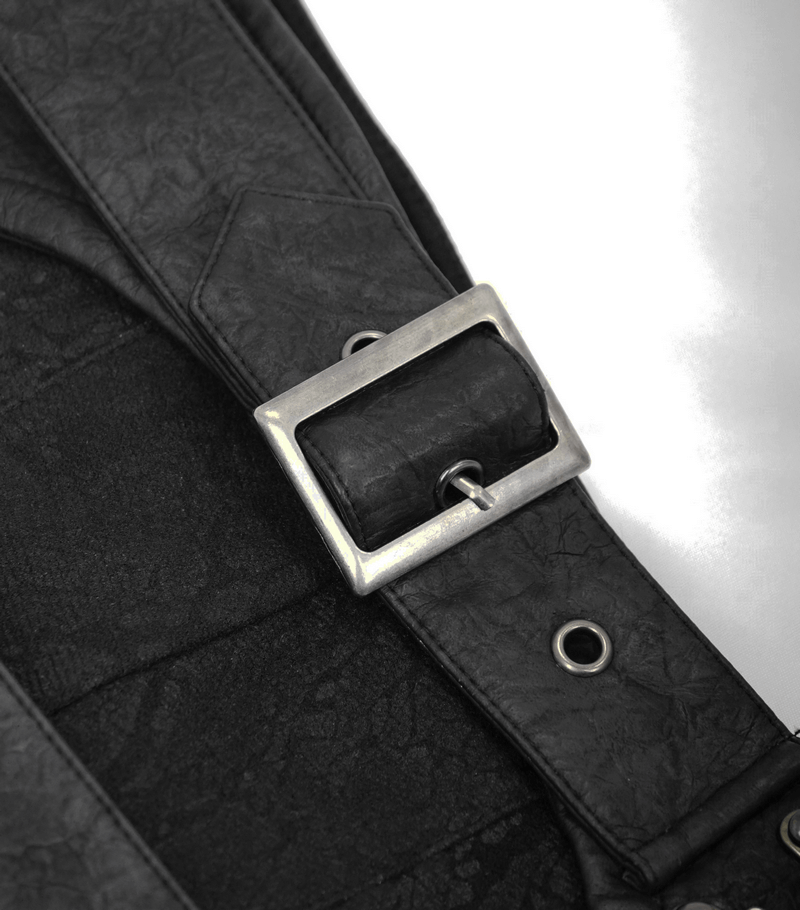 Close-up of silver buckle on a black men's kilt skirt with leather straps highlighting its gothic style.