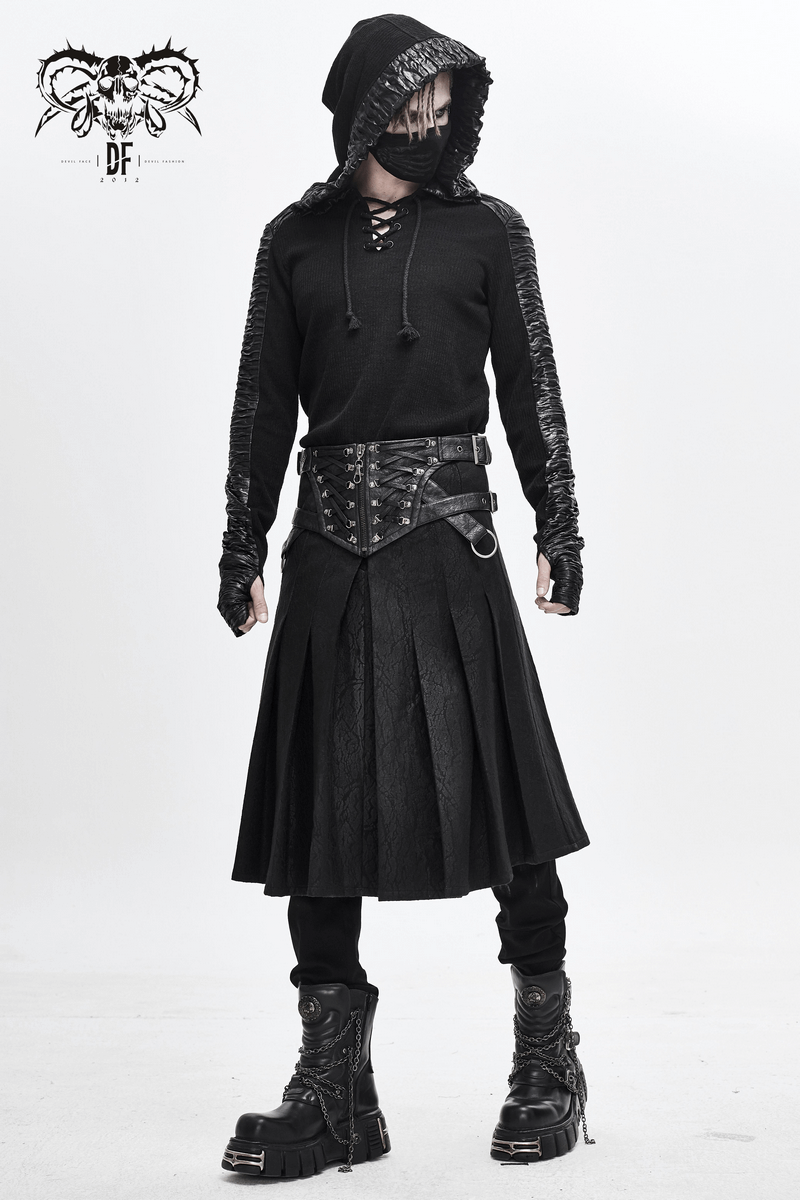 Stylish man in a black asymmetrical kilt skirt, hoodie, and thick boots, embodying edgy gothic fashion.