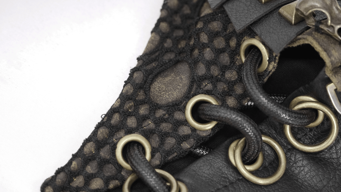 Close-up of a stylish dieselpunk glove featuring black netting, leather, and brass eyelets for a unique punk fashion accent.