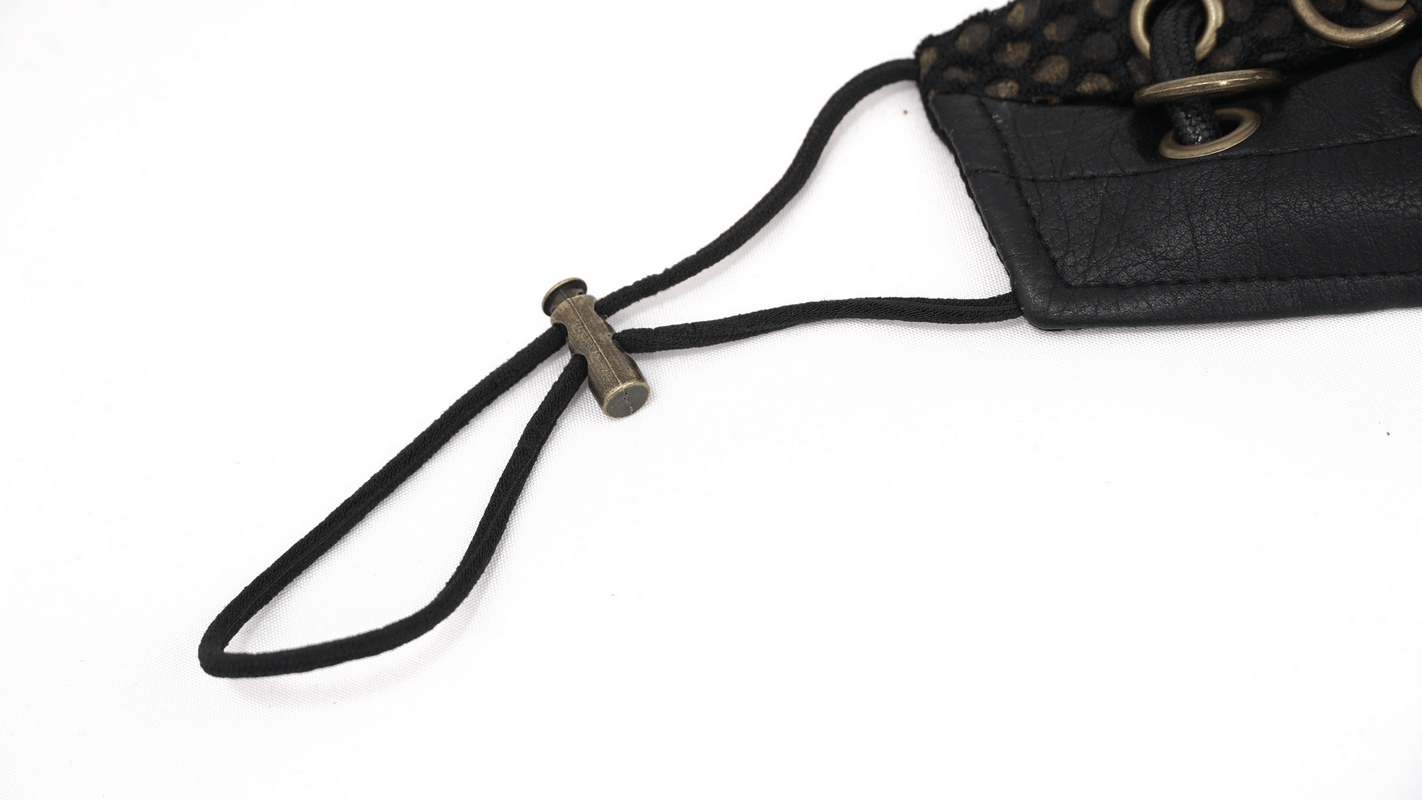 Close-up of a black leather mask strap with bronze fastening and decorative elements for a stylish punk look.