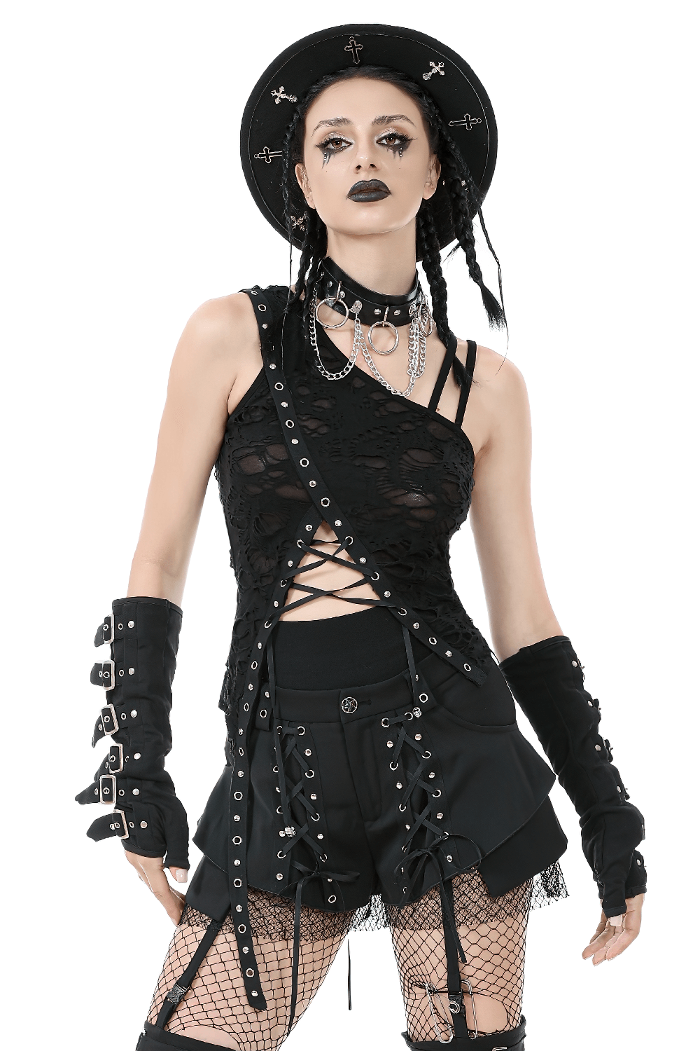 Edgy gothic model in distressed asymmetrical top with grommet straps, styled for punk fashion vibes.