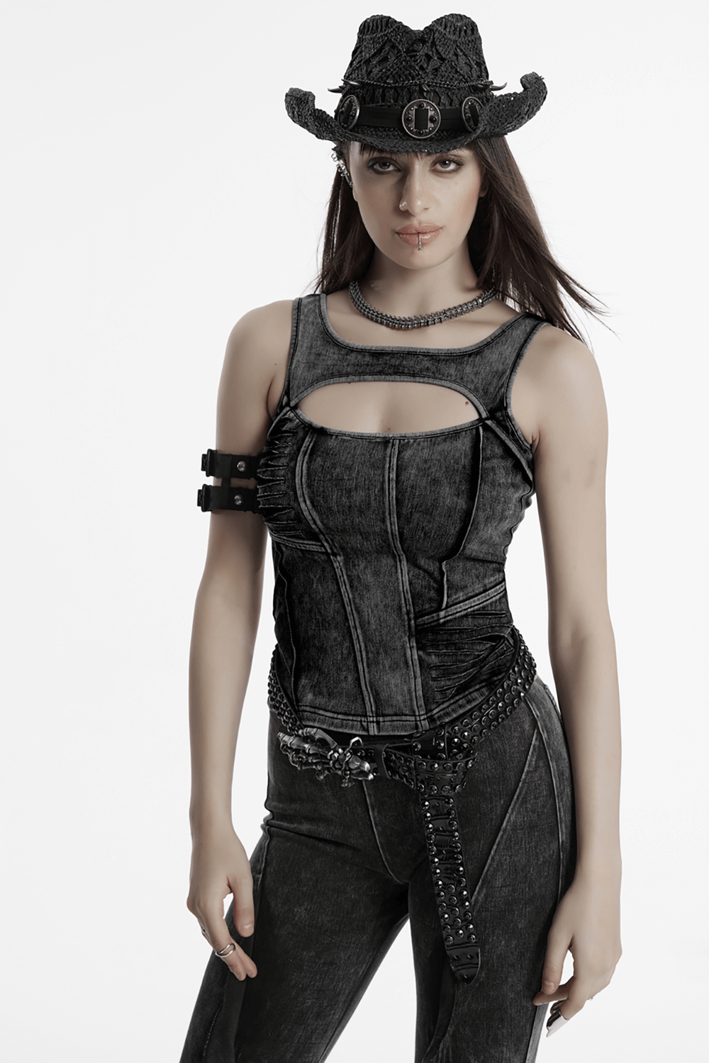 Distressed black denim tank top with cutout detail, styled for a punk-inspired, edgy look.