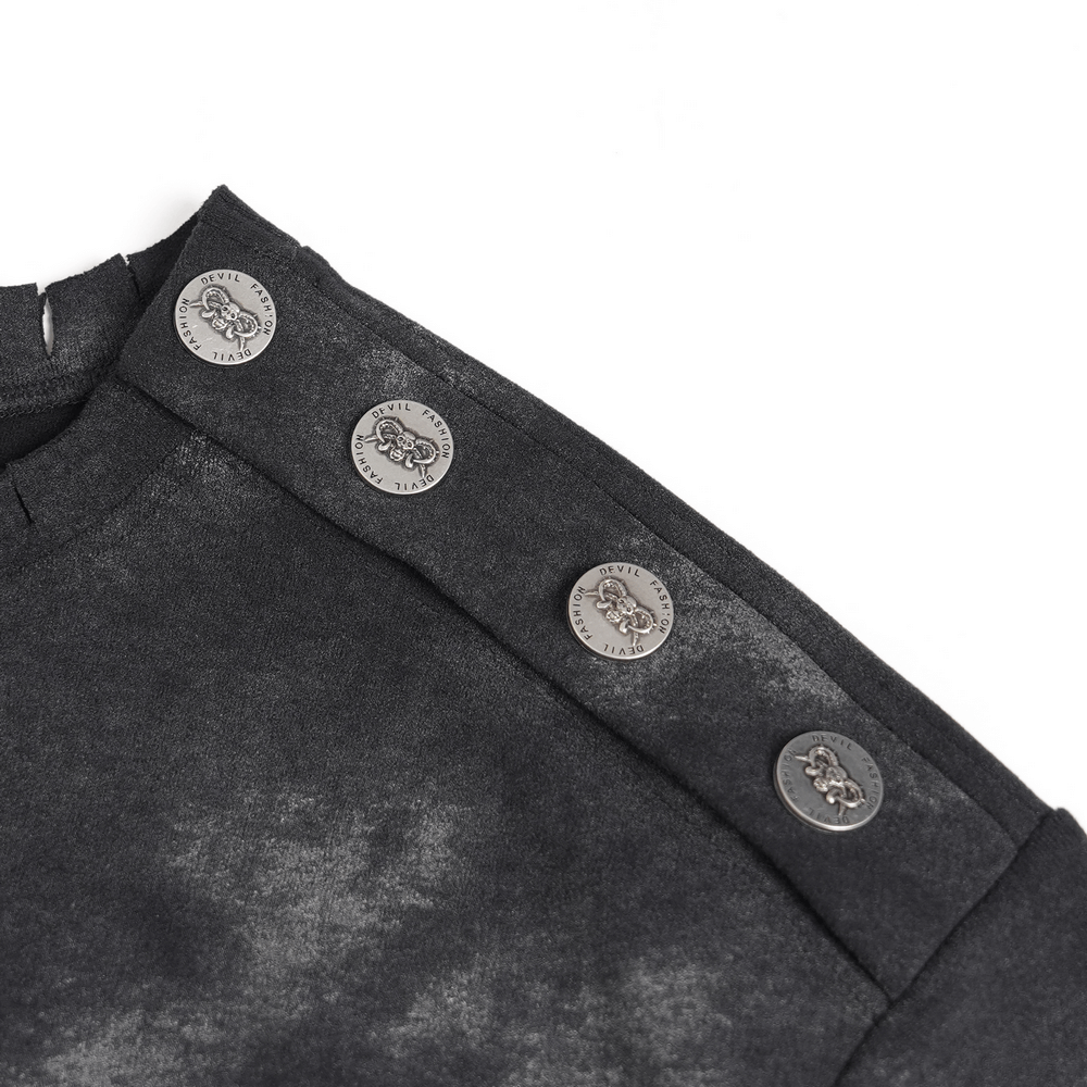 Close-up of the distressed black t-shirt's shoulder with decorative silver buttons accentuating the edgy design.
