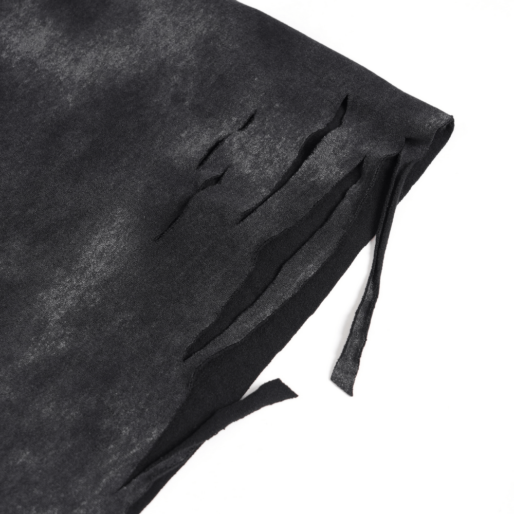 Close-up of distressed black fabric showing ripped details for an edgy look.