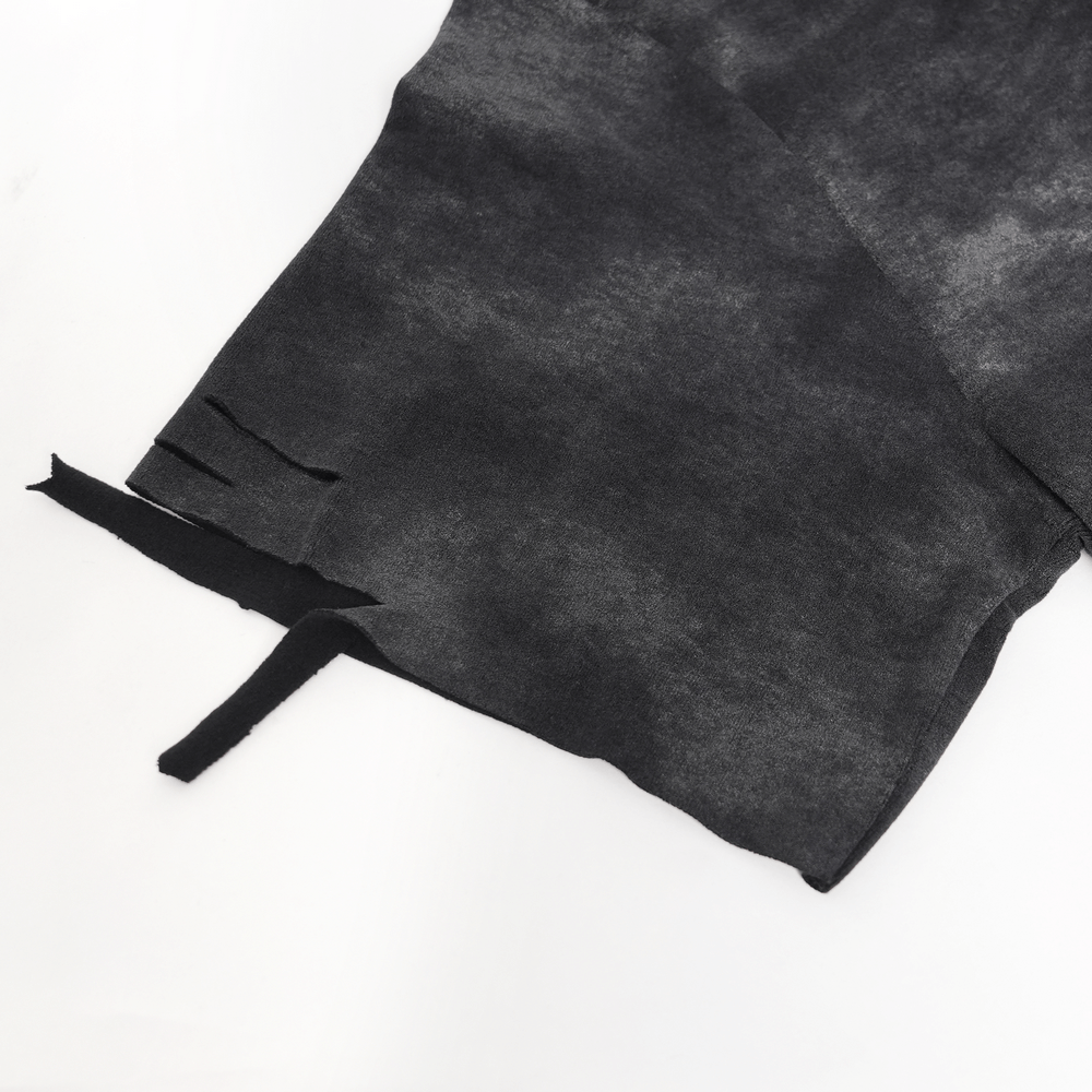 Close-up of the distressed hem detail of a gothic oversized tee with ties and rips, showcasing edgy fashion.