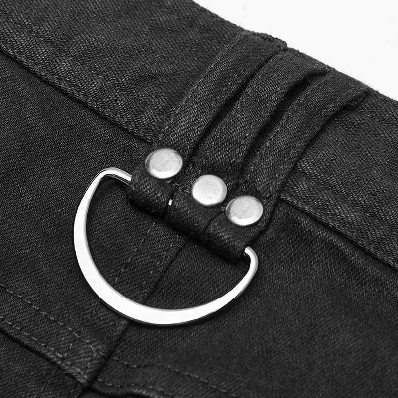 Close-up of distressed denim jeans waistband with metal ring detail, showcasing rugged style and punk fashion.
