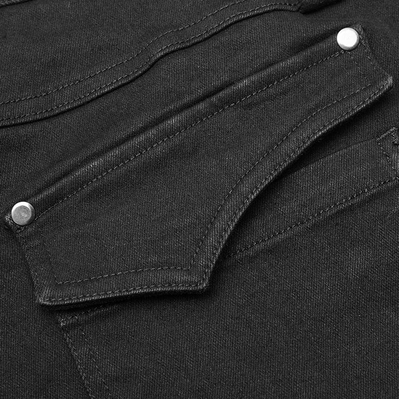 Close-up of distressed denim jeans with detailed knee armor pockets and metal buttons for a rugged look.