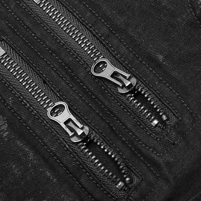Close-up of black zippered detail on distressed denim jeans with knee armor design.