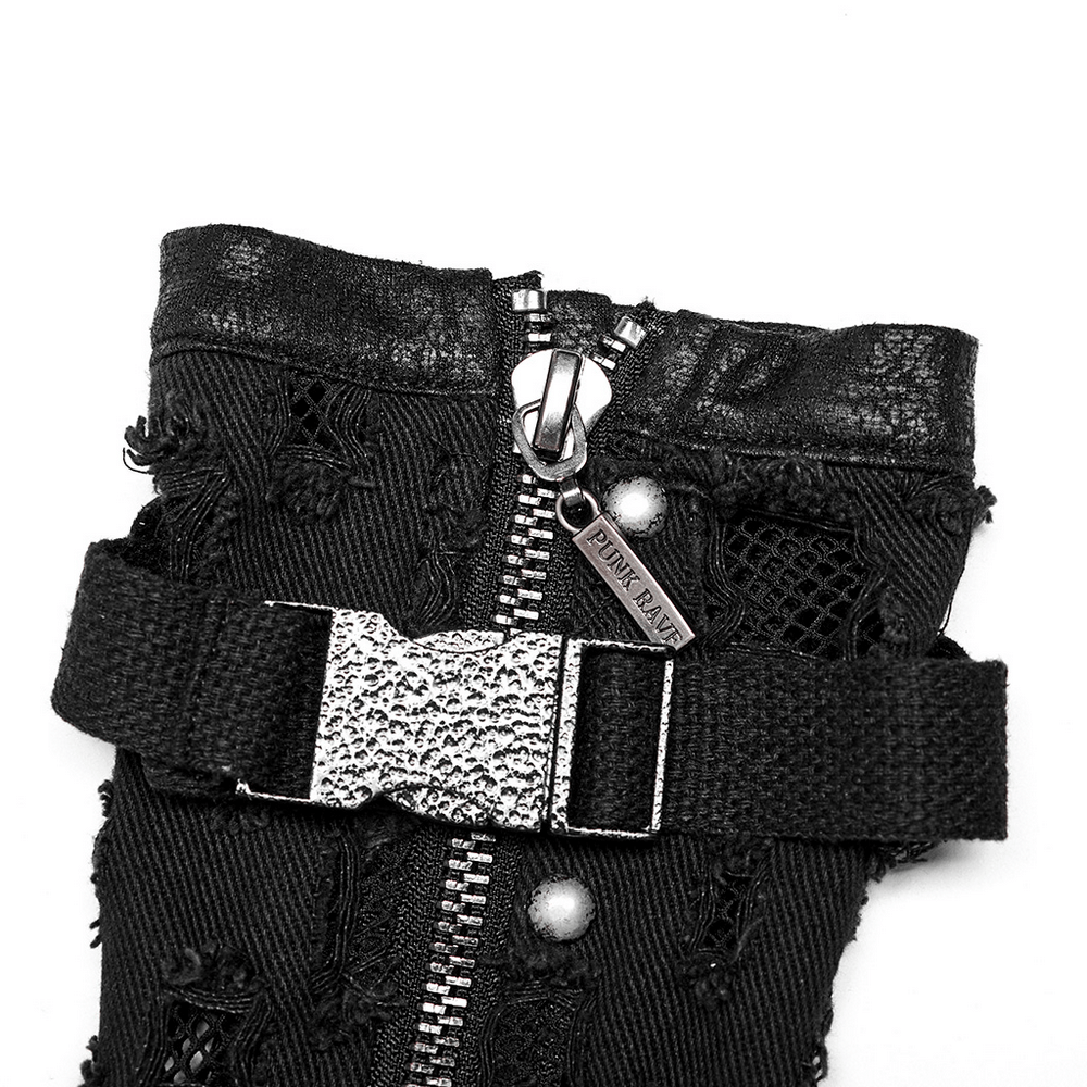 Close-up of distressed denim punk arm gloves with side zipper and uneven metal buckle detail.