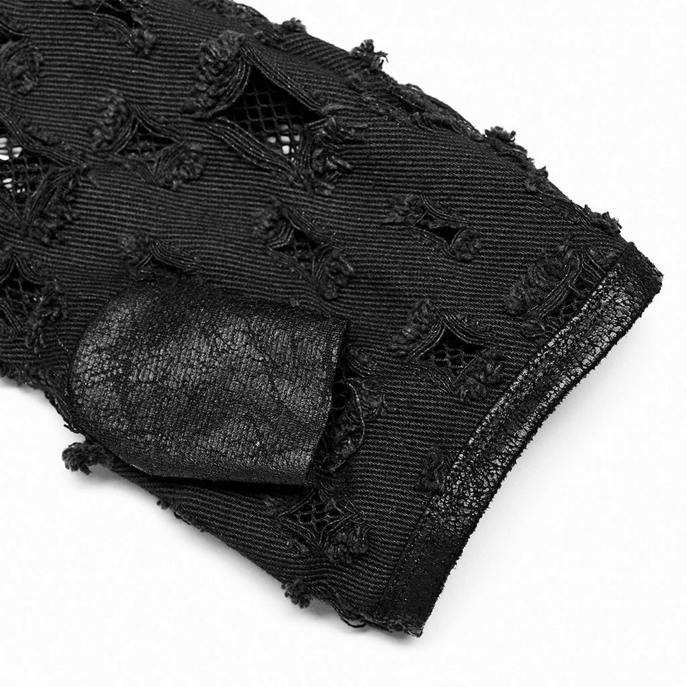 Close-up of distressed black denim punk arm glove with mesh and uneven metal buckle detail.