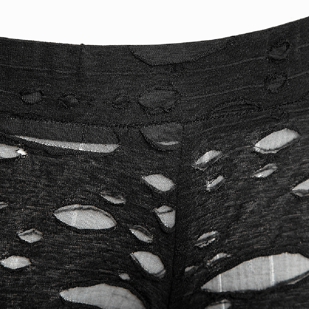 Close-up of distressed black mesh-panel leggings showcasing rip details for a bold gothic style.