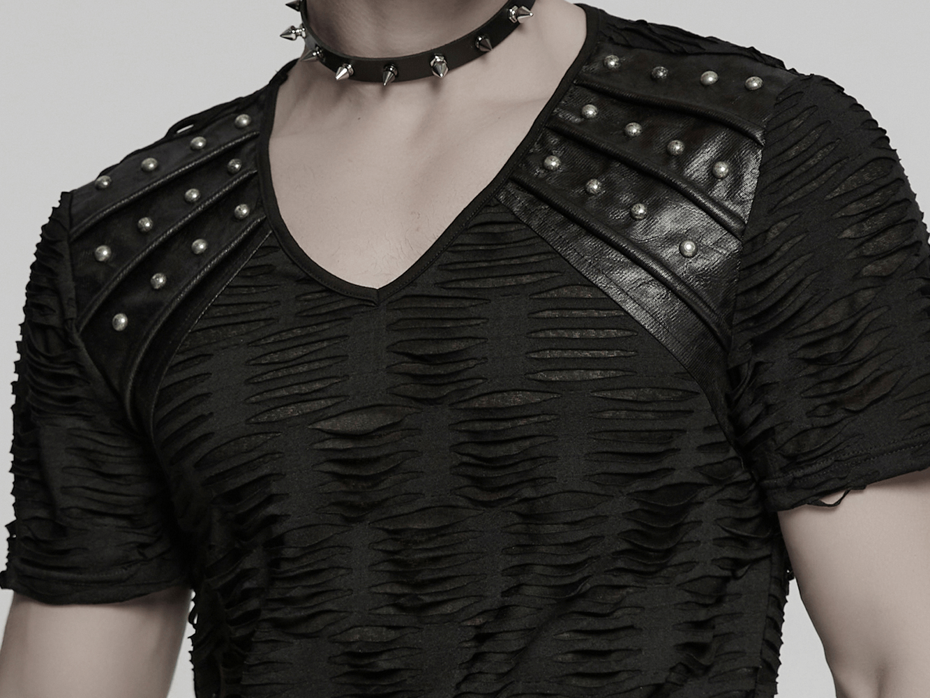 Distressed Gothic T-shirt with rivet shoulder detail for punk fashion lovers. Industrial style meets dark aesthetics.