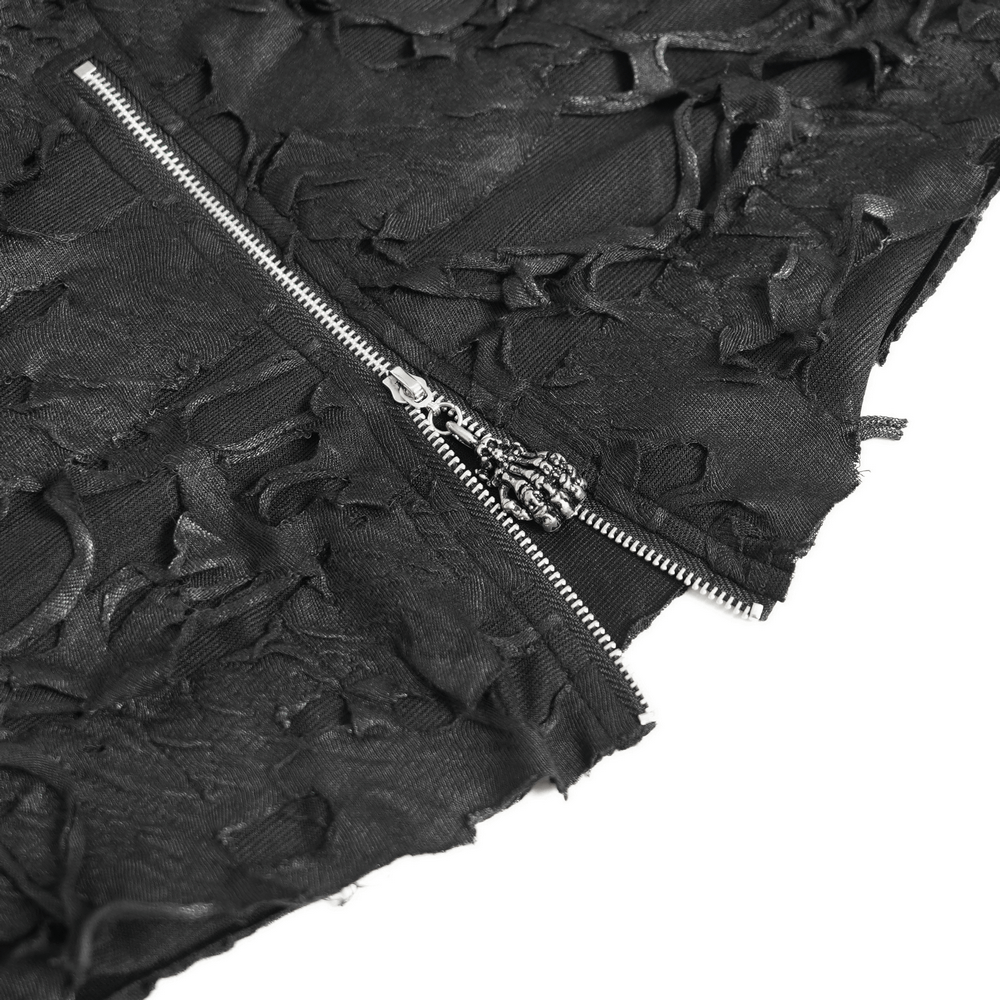 Close-up of distressed black off-shoulder top showing ripped fabric and front zipper detail.