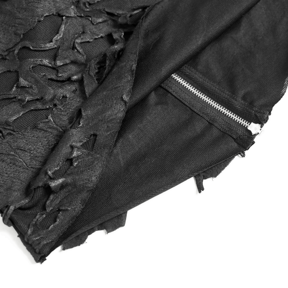 Close-up of distressed off-shoulder top showing ripped fabric and front zipper detail.
