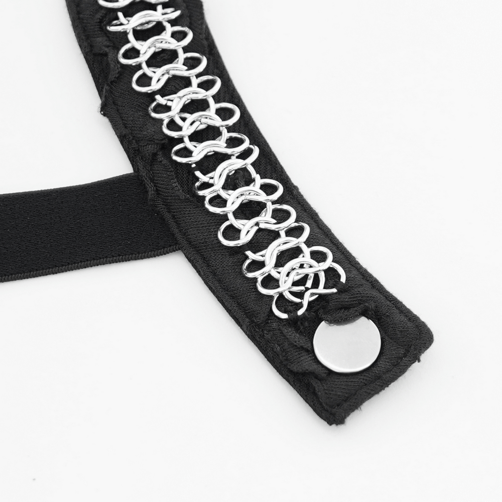 Close-up of black harness strap featuring metal chain details for a punk-inspired off-shoulder top.