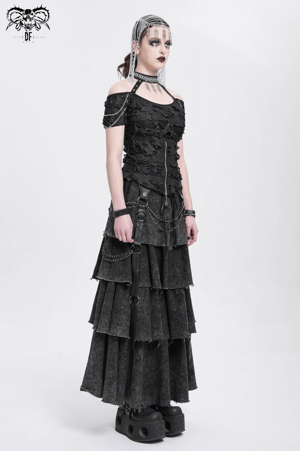 Punk distressed off-shoulder top with chains, paired with a layered skirt and edgy accessories.