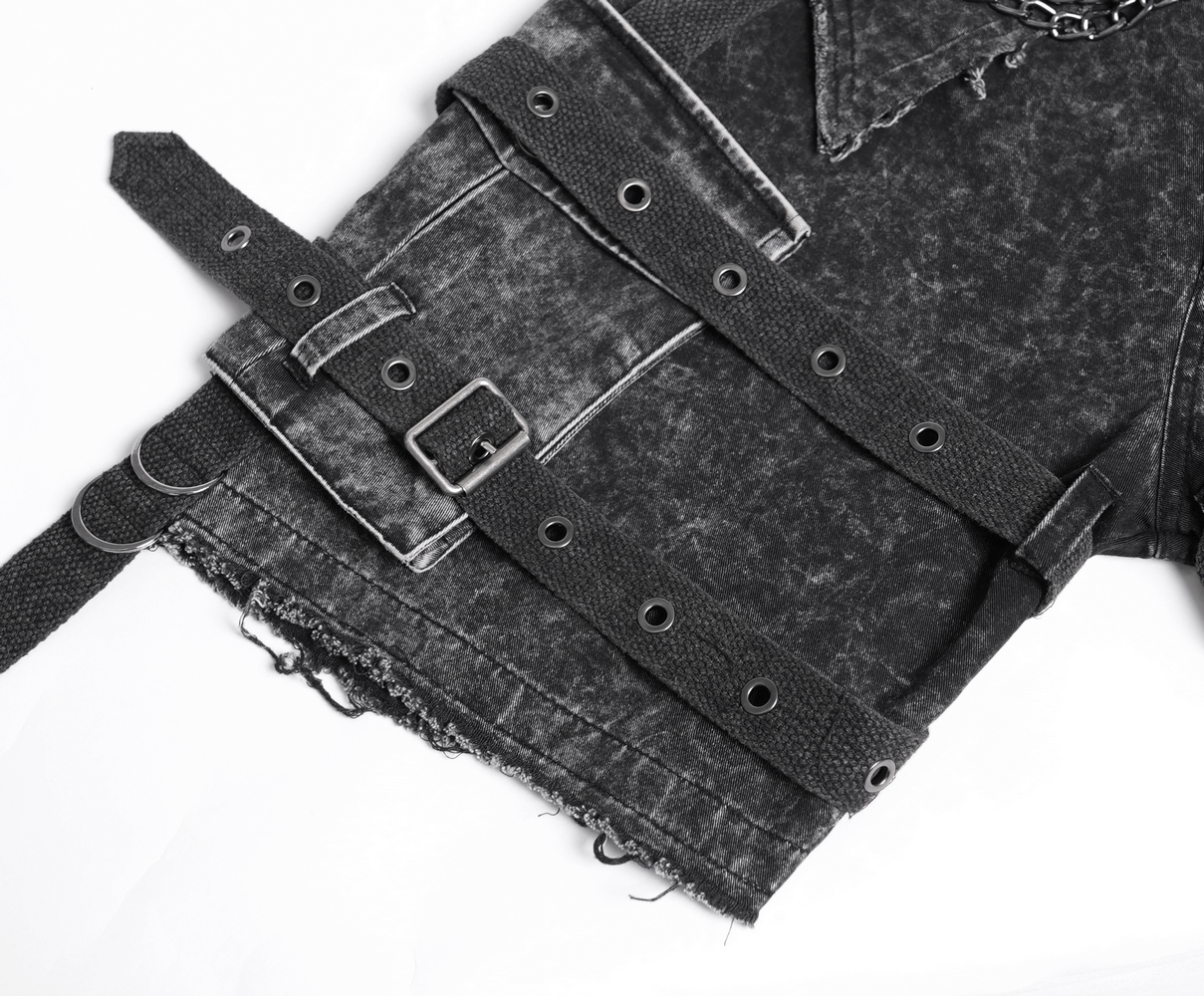 Close-up of distressed punk pants with straps, buckles, and metal chains, showcasing edgy fashion details.