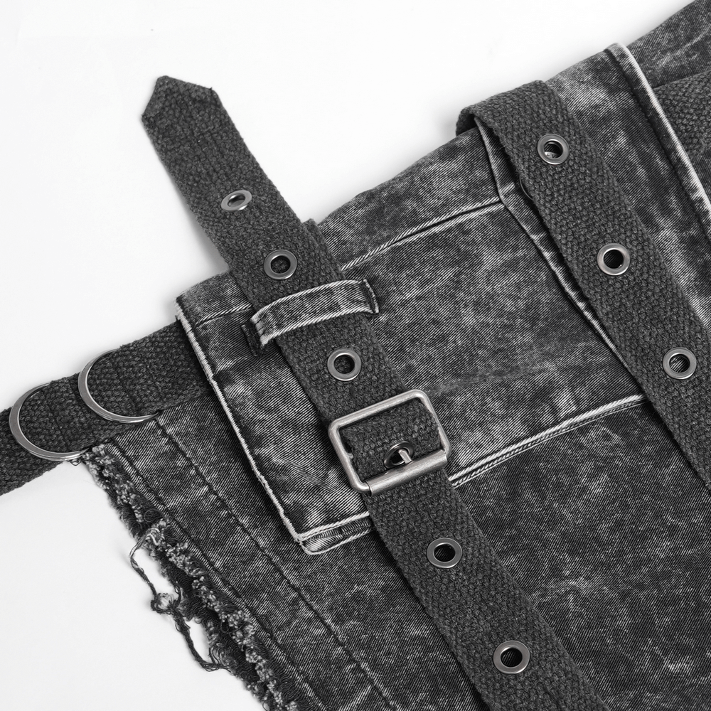Distressed black pants featuring adjustable buckles and ripped details for a punk-inspired look.