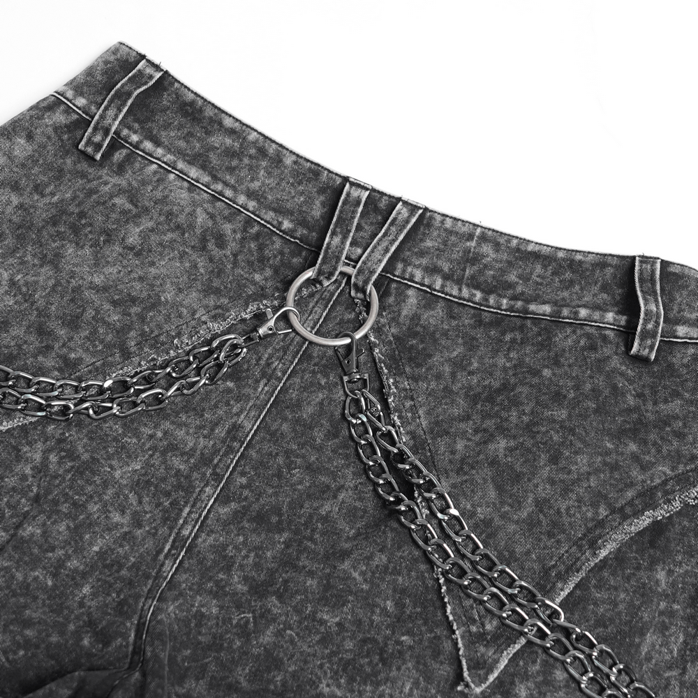 Close-up of distressed black pants featuring chains and buckle details, perfect for punk fashion enthusiasts.