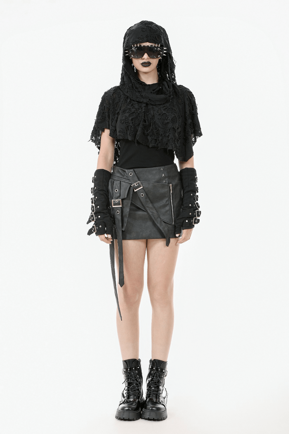 Distressed punk hooded poncho cape with tattered design, styled with edgy black accessories and combat boots.