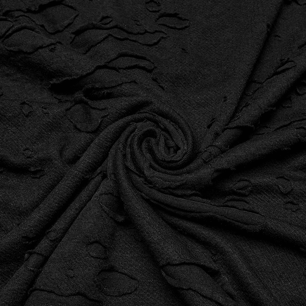 Close-up of distressed black fabric showcasing tattered texture and edgy design for punk fashion.