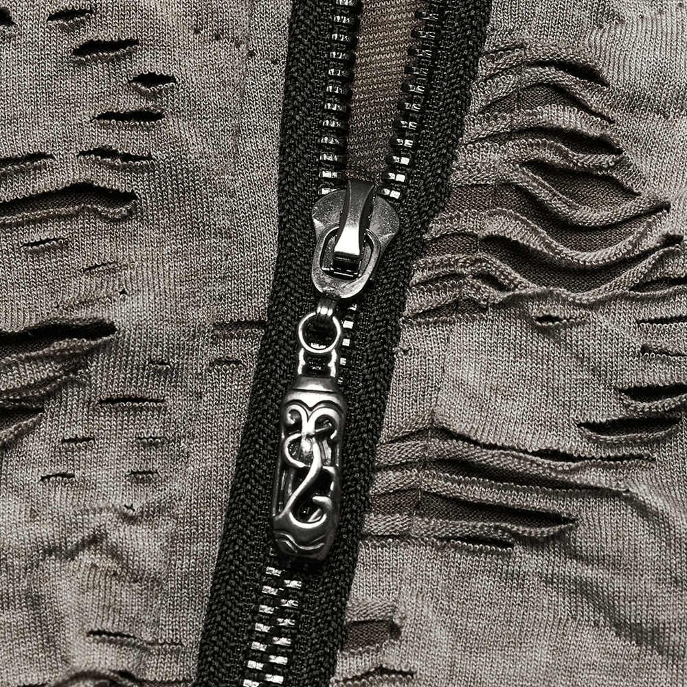 Close-up of distressed punk T-shirt zipper showing tattered texture and industrial style details.