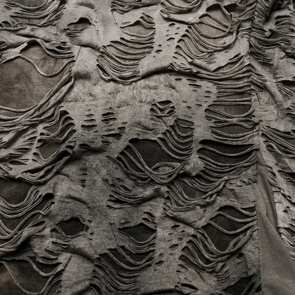 Distressed punk fabric showcasing unique tattered textures and raw edges, embodying an edgy urban aesthetic.