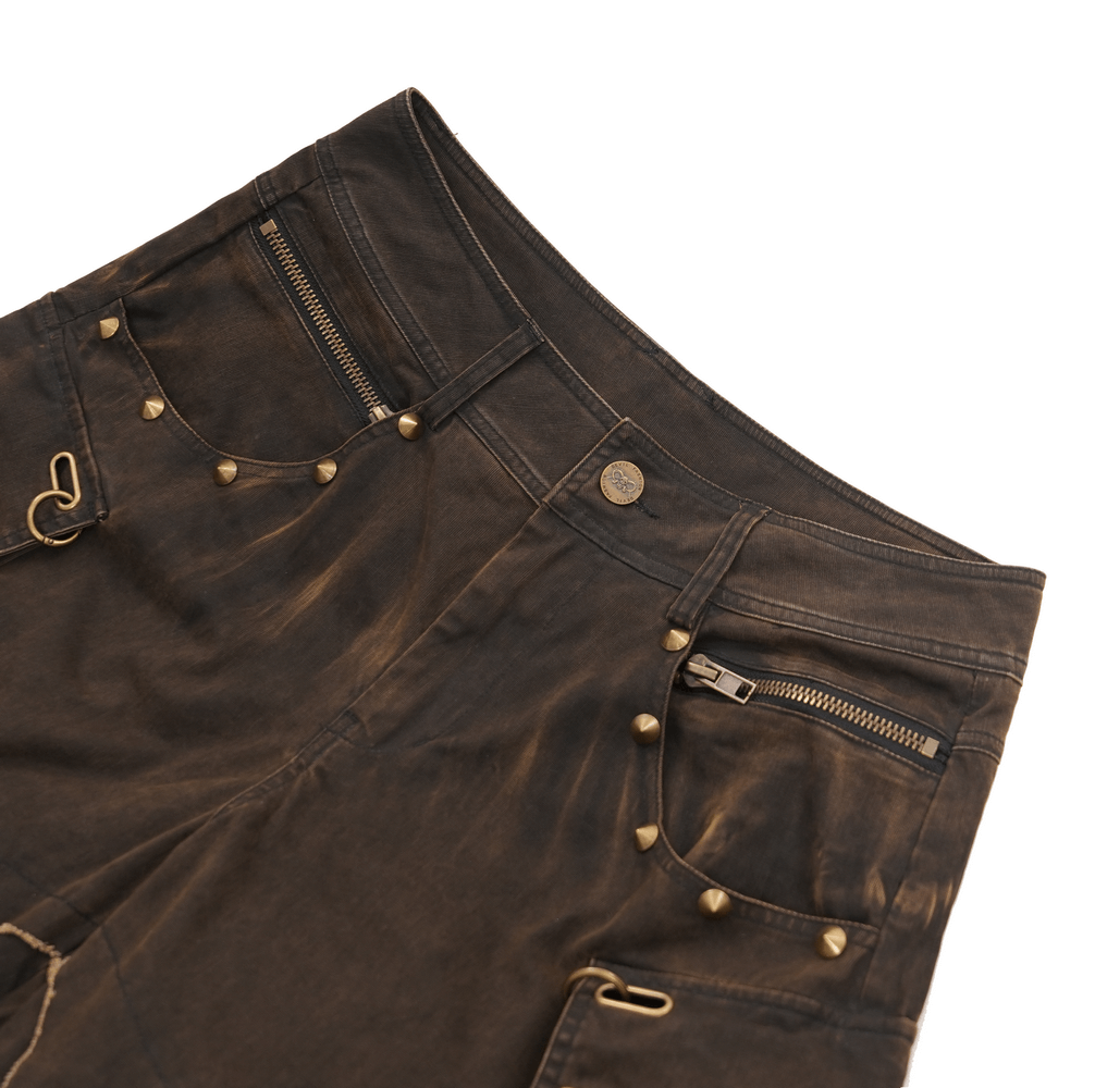 Distressed male wide leg pants featuring grommets, raw hem, and practical pockets in dark wash style.