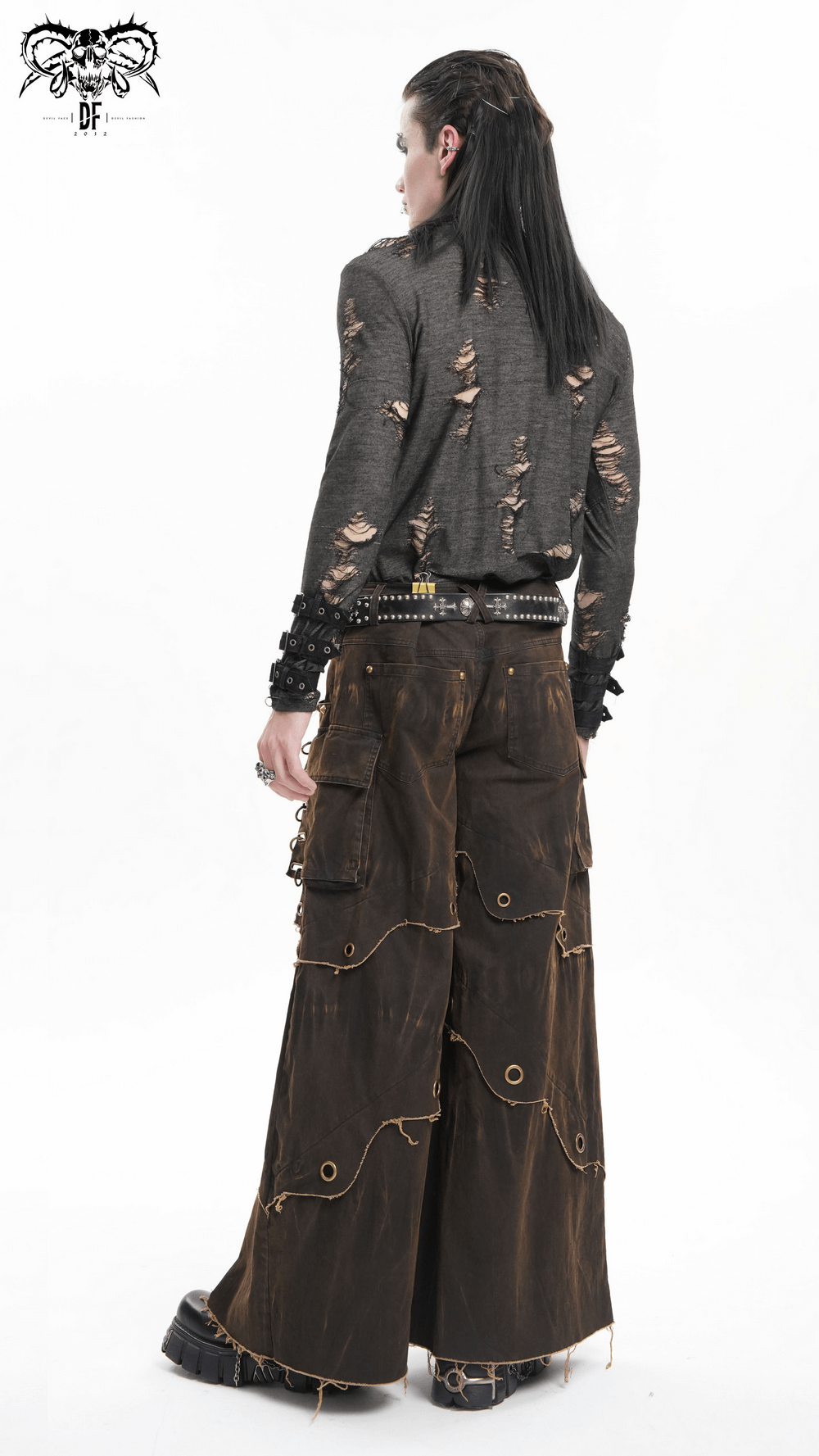 Distressed male wide-leg pants with grommets, raw hem, and pockets, showcasing a bohemian style and edgy look.