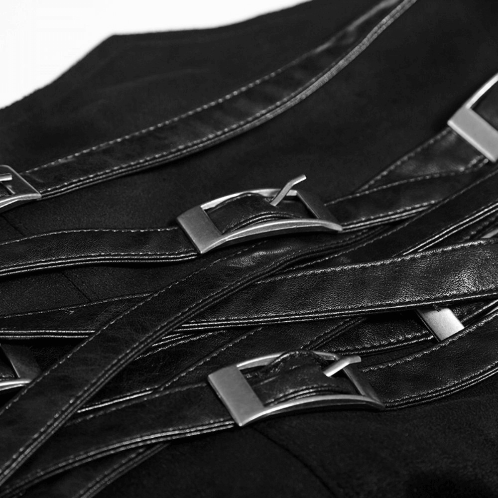 Close-up of sleek black faux leather straps with metal buckles on a punk skirt, showcasing edgy style.