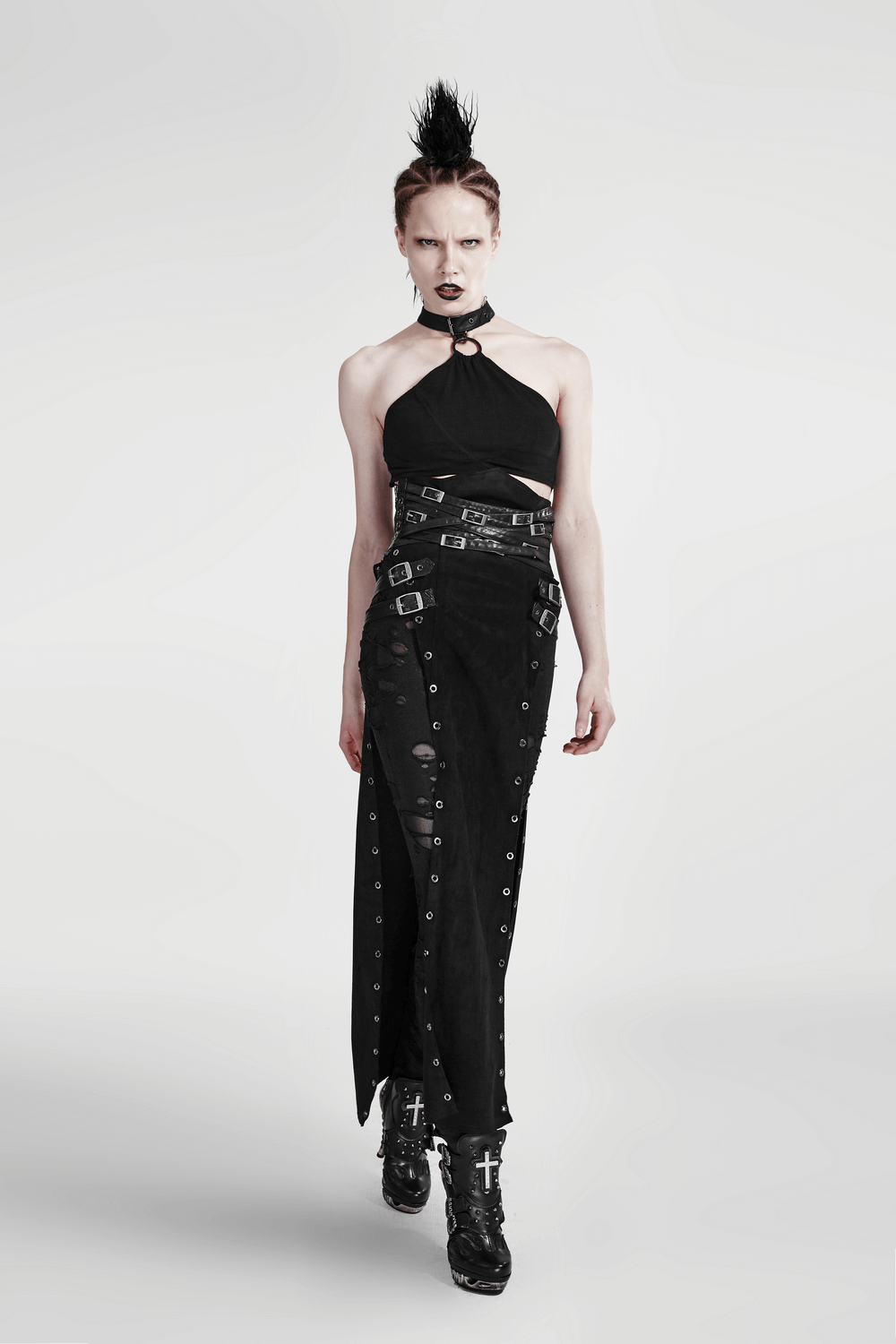 Model wearing a double-sided split punk skirt with metal eyelets and a chic black top, showcasing edgy punk style.