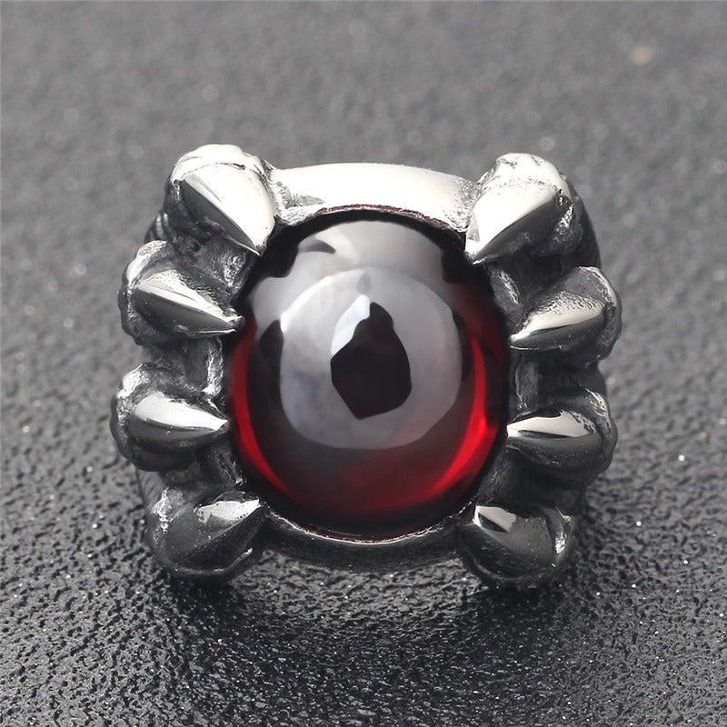 Dragon claw ring featuring a striking red CZ stone, perfect for gothic jewelry lovers.