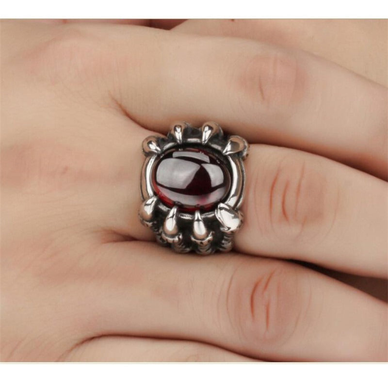 Dragon Claw stainless steel ring with red CZ gemstone, showcasing gothic style on a hand.