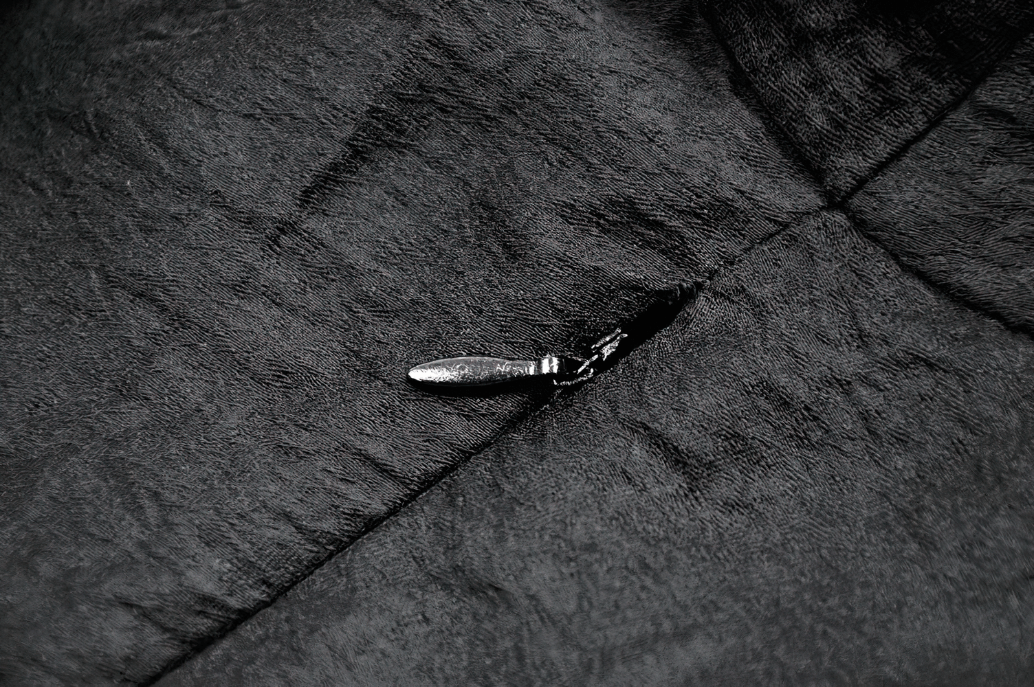 Dramatic Lace High Low Dress with Corset Back and Ruffles zipper detail close-up on fabric