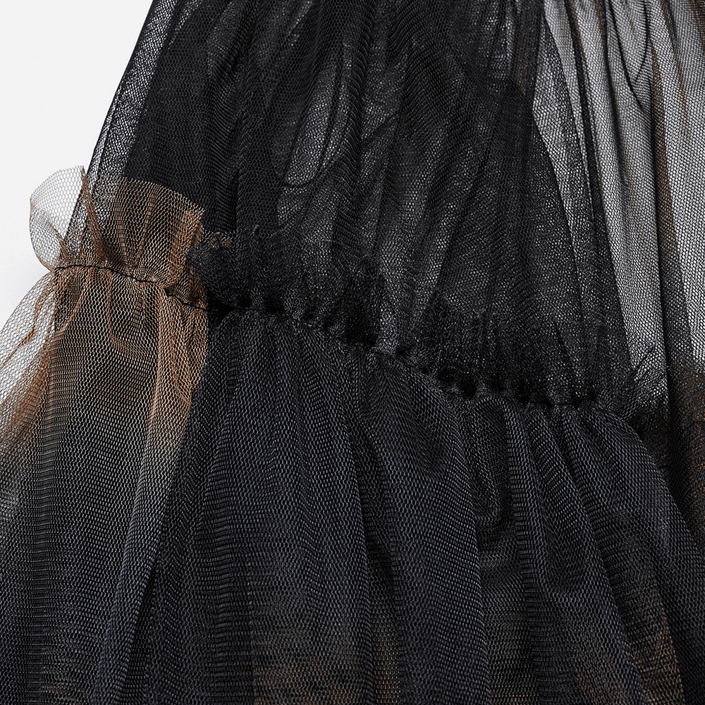 Close-up of dramatic layered mesh skirt showing black and brown tulle fabric texture, perfect for bold fashion statements.