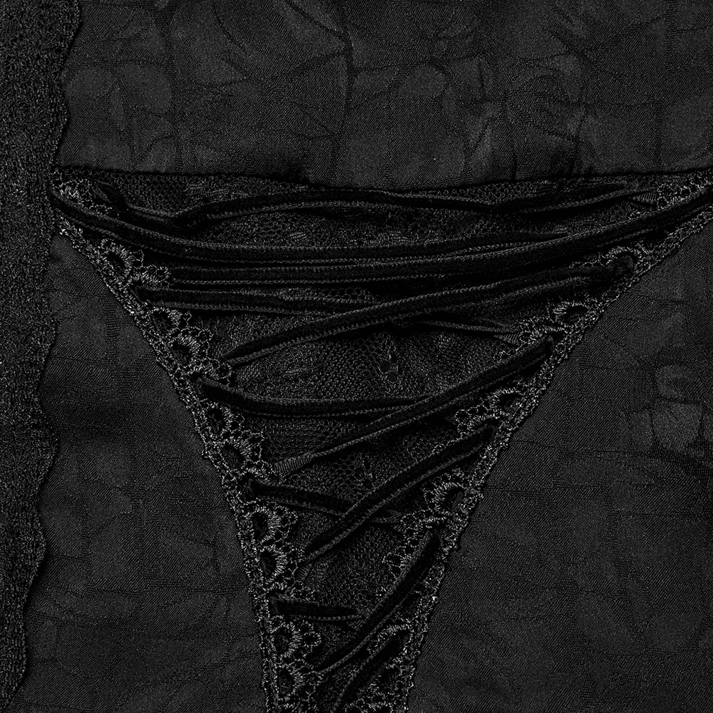 Close-up of intricate black lace detailing on a gothic blouse, showcasing elegant textures and design.